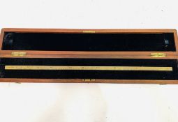 A mahogany boxed brass standard measure gauge