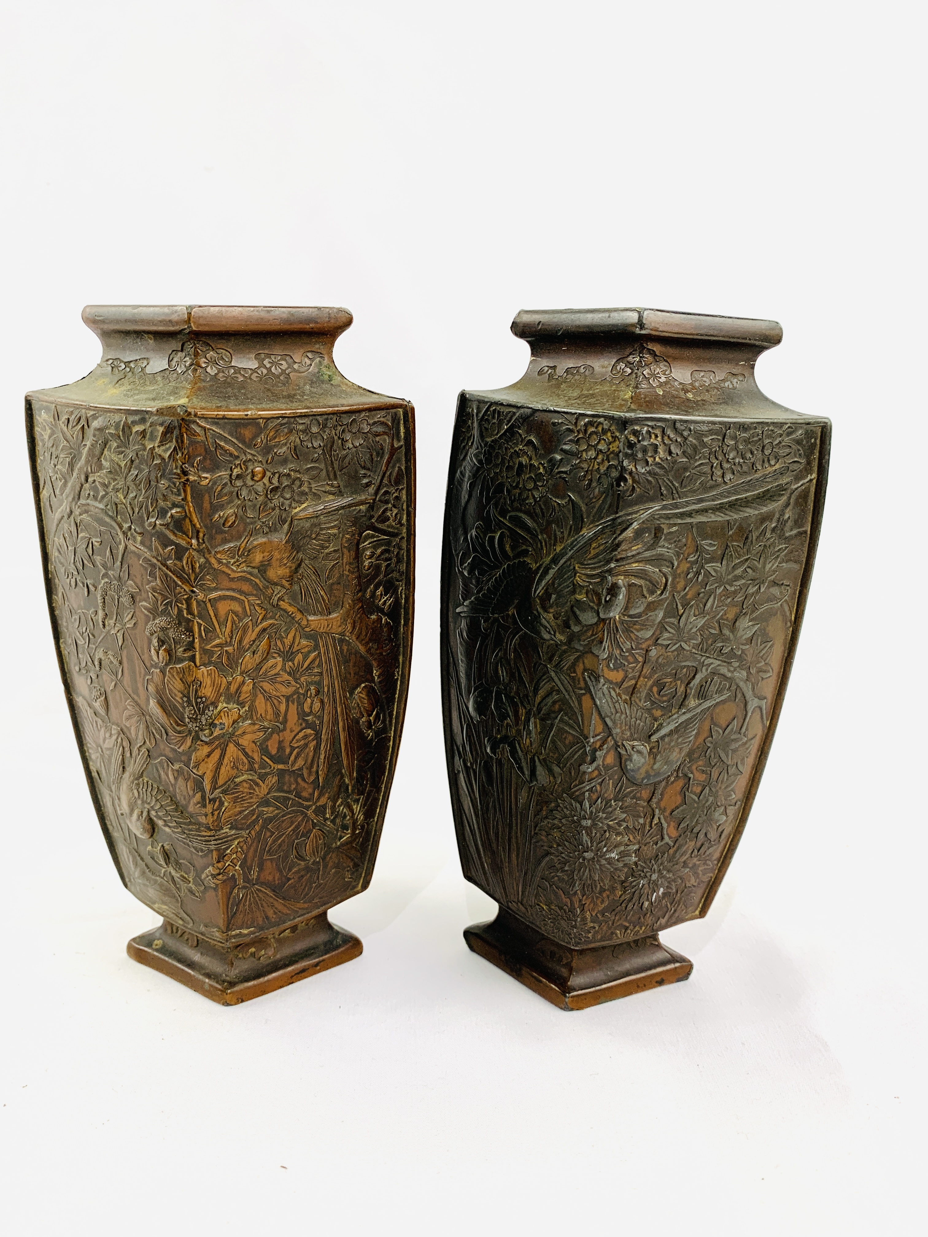 Two Oriental metal vases decorated with flora and fauna