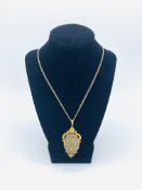9ct gold hallmarked pendant decorated with diamond mounted flowers on oval opaque cabochon