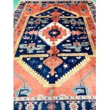 Hand knotted blue and red ground rug