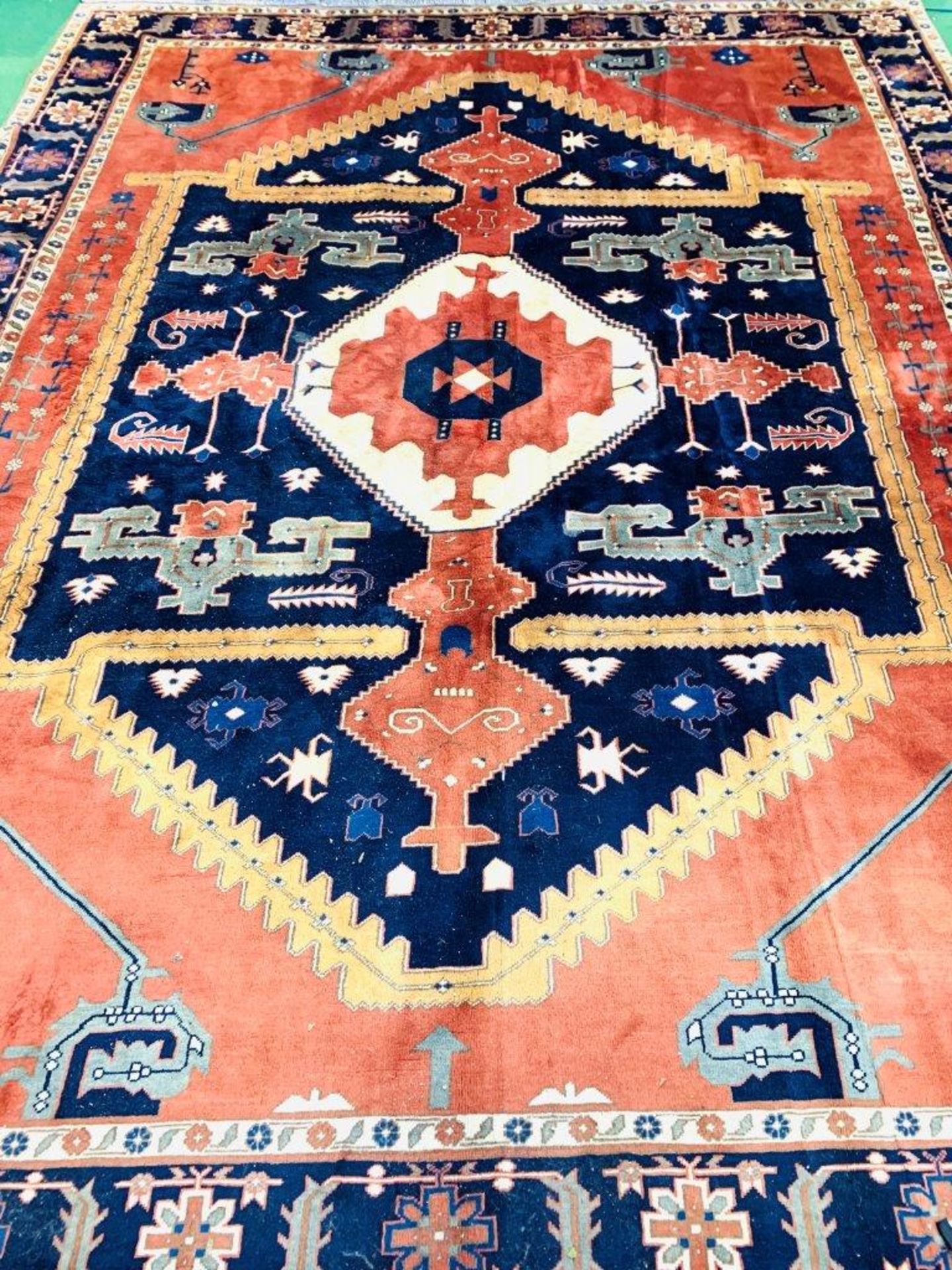 Hand knotted blue and red ground rug
