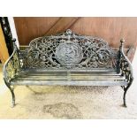 A long black painted cast iron garden seat in the style of Coalbrookdale