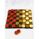 Inlaid chequerboard together with 14 red and 13 white draughts