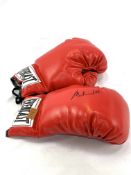 Pair of red Everlast boxing gloves, one signed Muhammad Ali