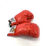 Pair of red Everlast boxing gloves, one signed Muhammad Ali