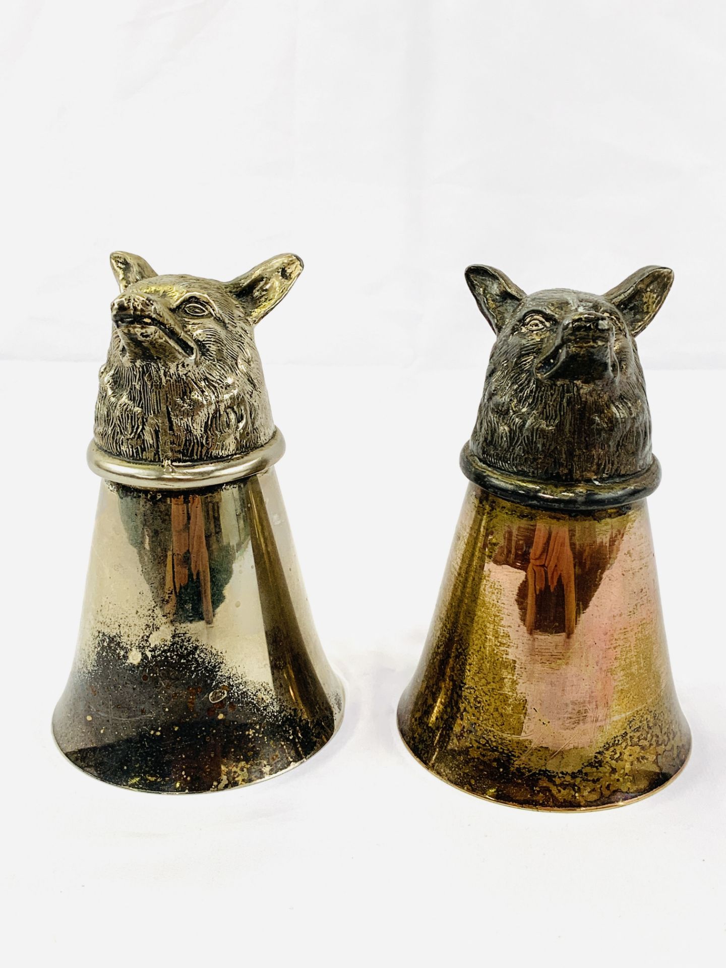 Two silver plate stirrup cups with foxes' heads