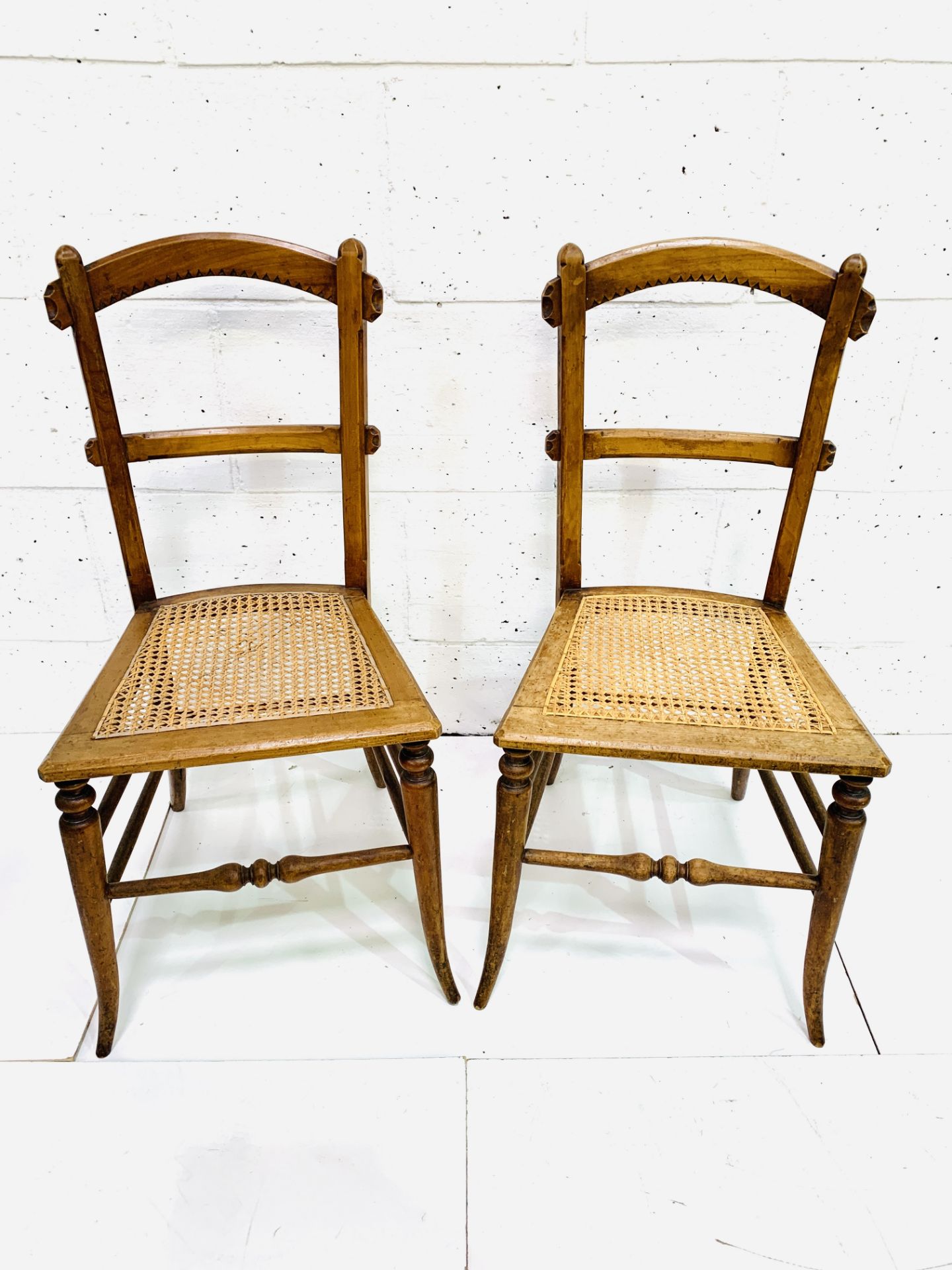 Pair of decorative cane seat arched back bedroom chairs