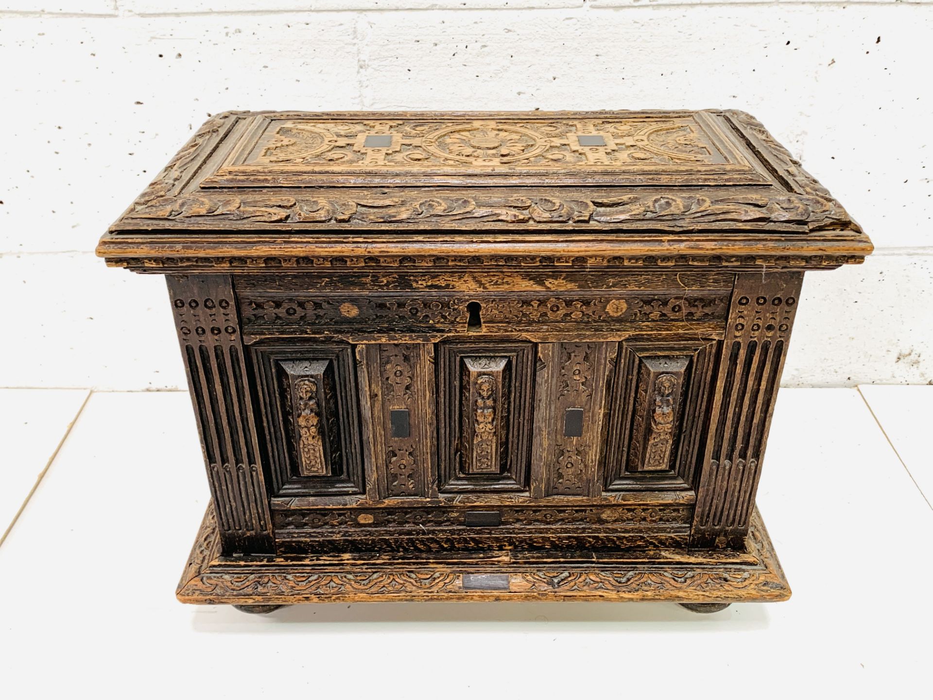 Carved oak casket with ebony inserts
