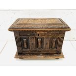 Carved oak casket with ebony inserts