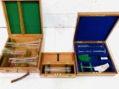 Three boxes of standard glass measures