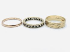A 9ct gold band, a 9ct gold decorated band; and a 9ct gold and white stone eternity ring