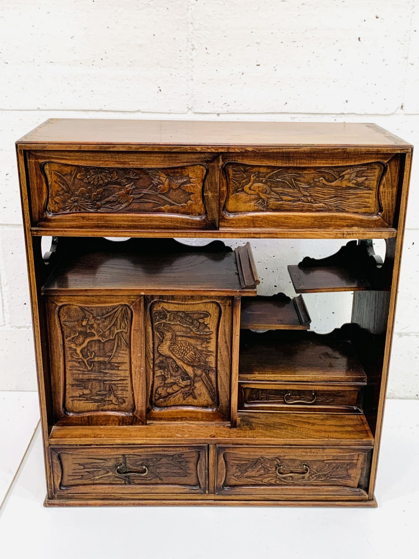 A carved hardwood Japanese cabinet