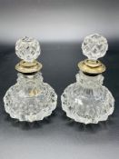 A pair of cut glass scent bottles complete with stopper, silver rims hallmarked London 1929