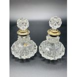 A pair of cut glass scent bottles complete with stopper, silver rims hallmarked London 1929