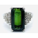 White gold ring with large baguette cut chrome tourmaline and diamond shoulders