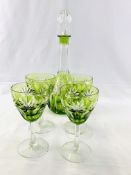 Green cut to clear faceted glass decanter with four wine glasses