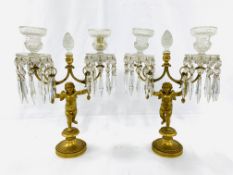 A pair of early 19th Century figural putti gilt bronze and crystal glass candelabra