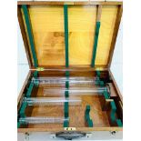 A box containing four glass measures