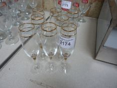 Eight gold trimmed champagne flutes