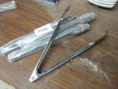 Four stainless steel tongs