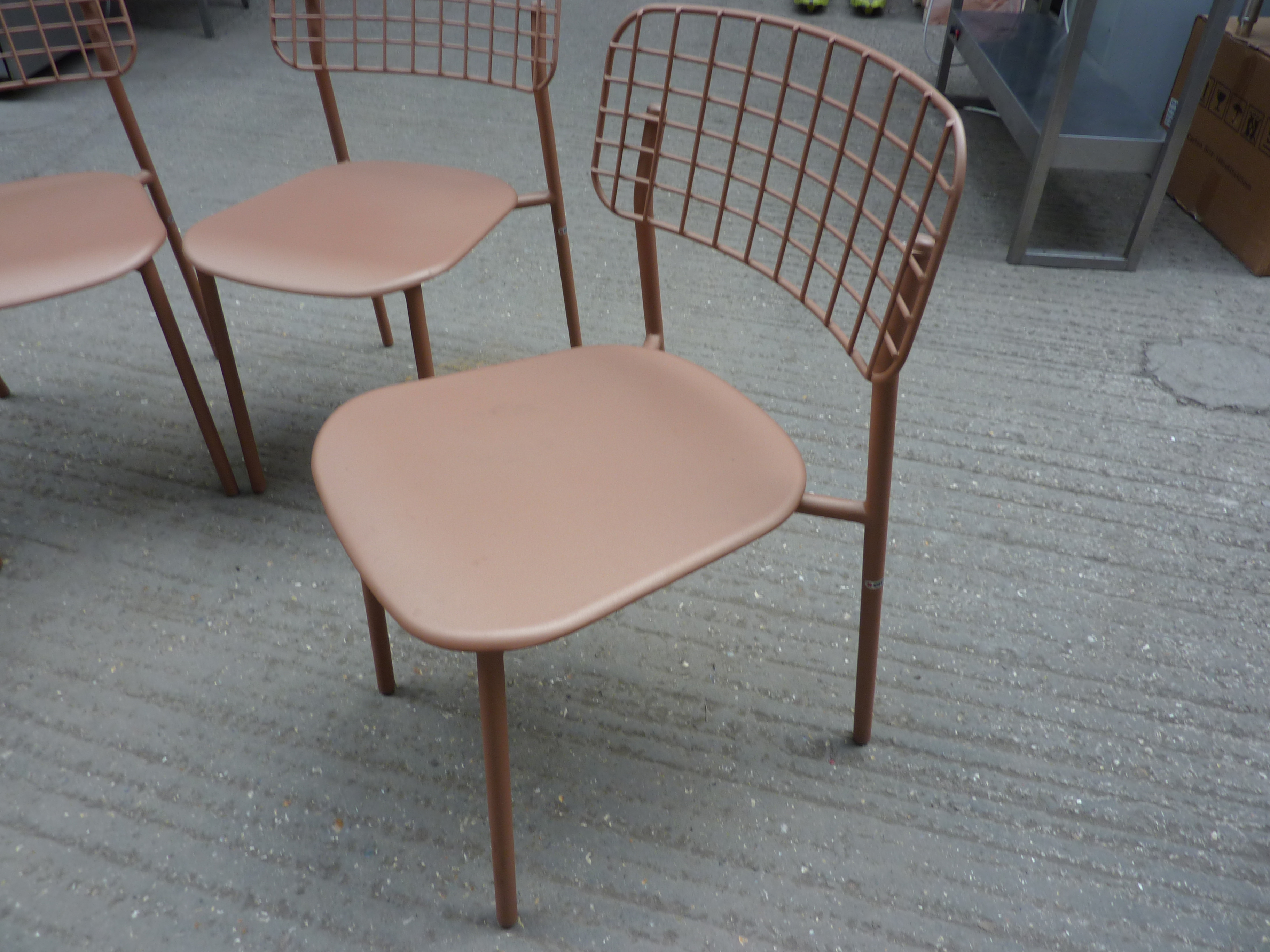 Four Emu metal stacking chairs