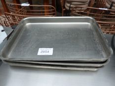 Three stainless steel baking trays