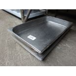 Three stainless steel trays