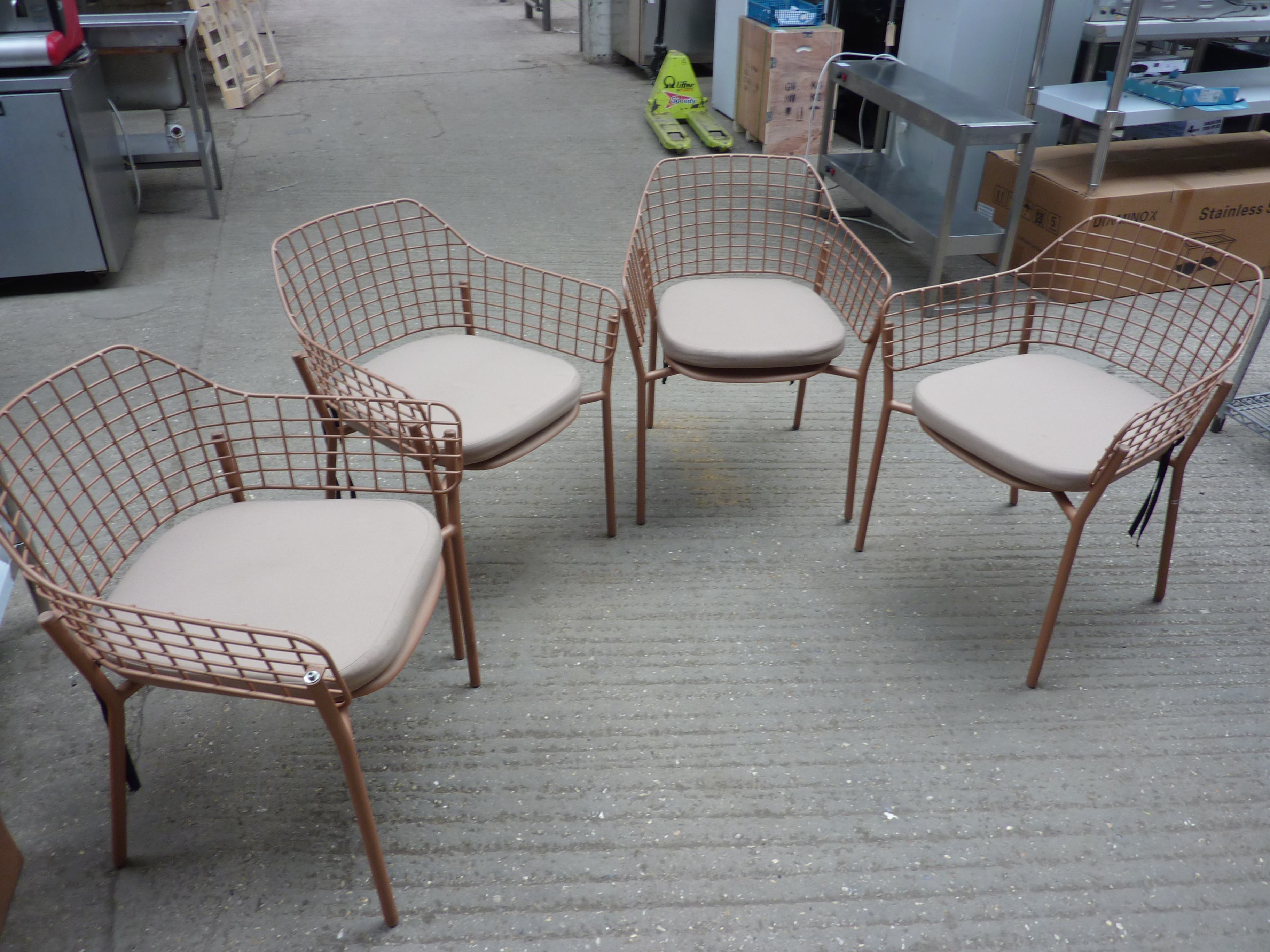 Four Emu metal stacking armchairs with four cushions