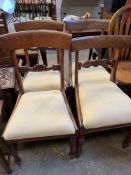 Four upholstered mahogany framed dining chairs with drop-in seats; not matching