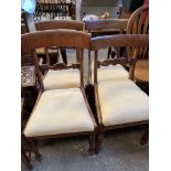 Four upholstered mahogany framed dining chairs with drop-in seats; not matching