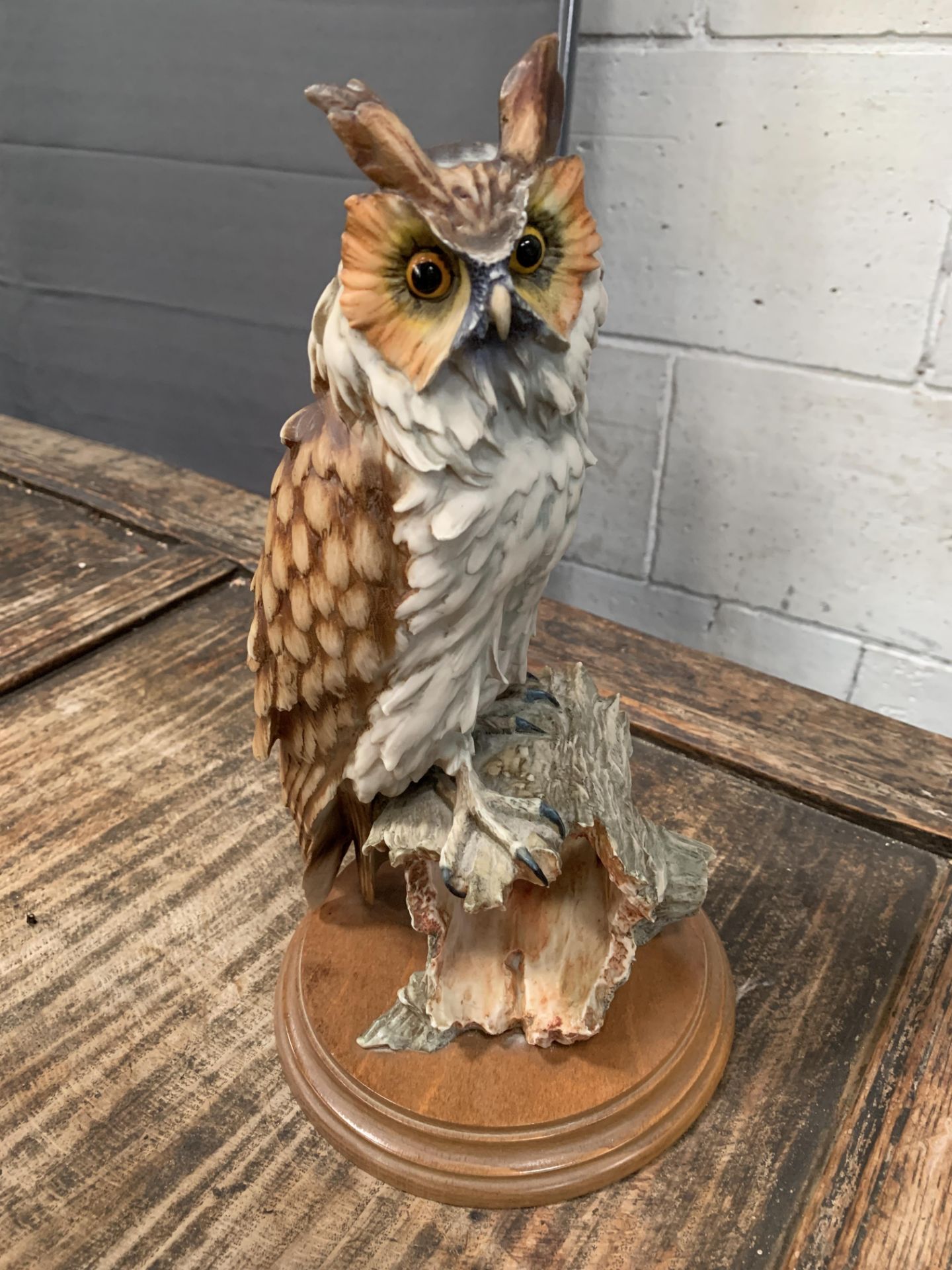 Resin model of an owl on wooden base, signed by artist