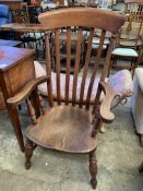 Elm open armchair together with a wooden standard lamp.