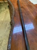 Carved ebony walking stick with brass tip