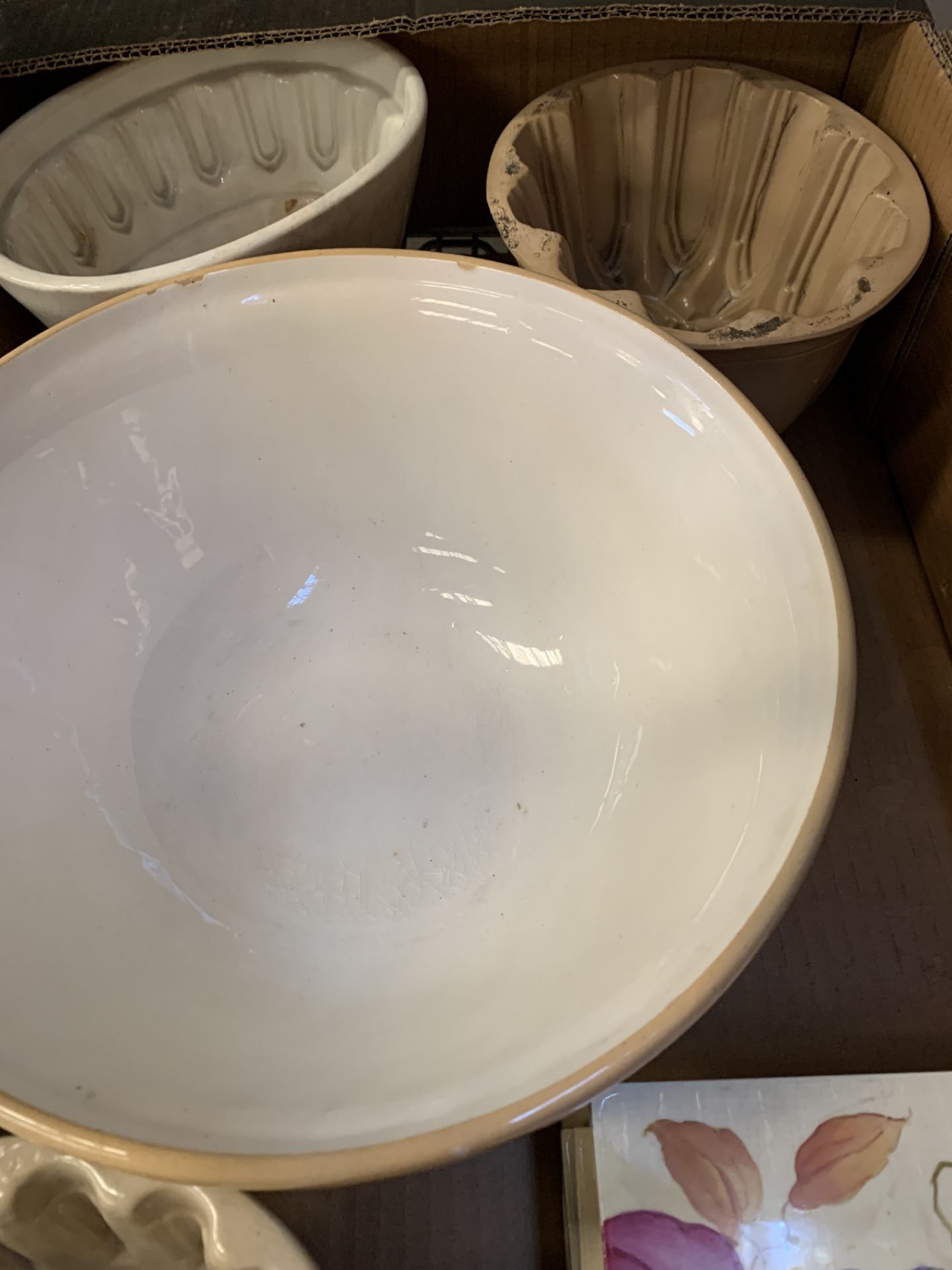 A stoneware mixing bowl, three stoneware jelly moulds and 6 decorative tiles.