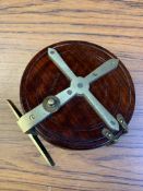 A wooden brass mounted fishing reel