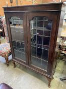 A mahogany glass fronted bookcase
