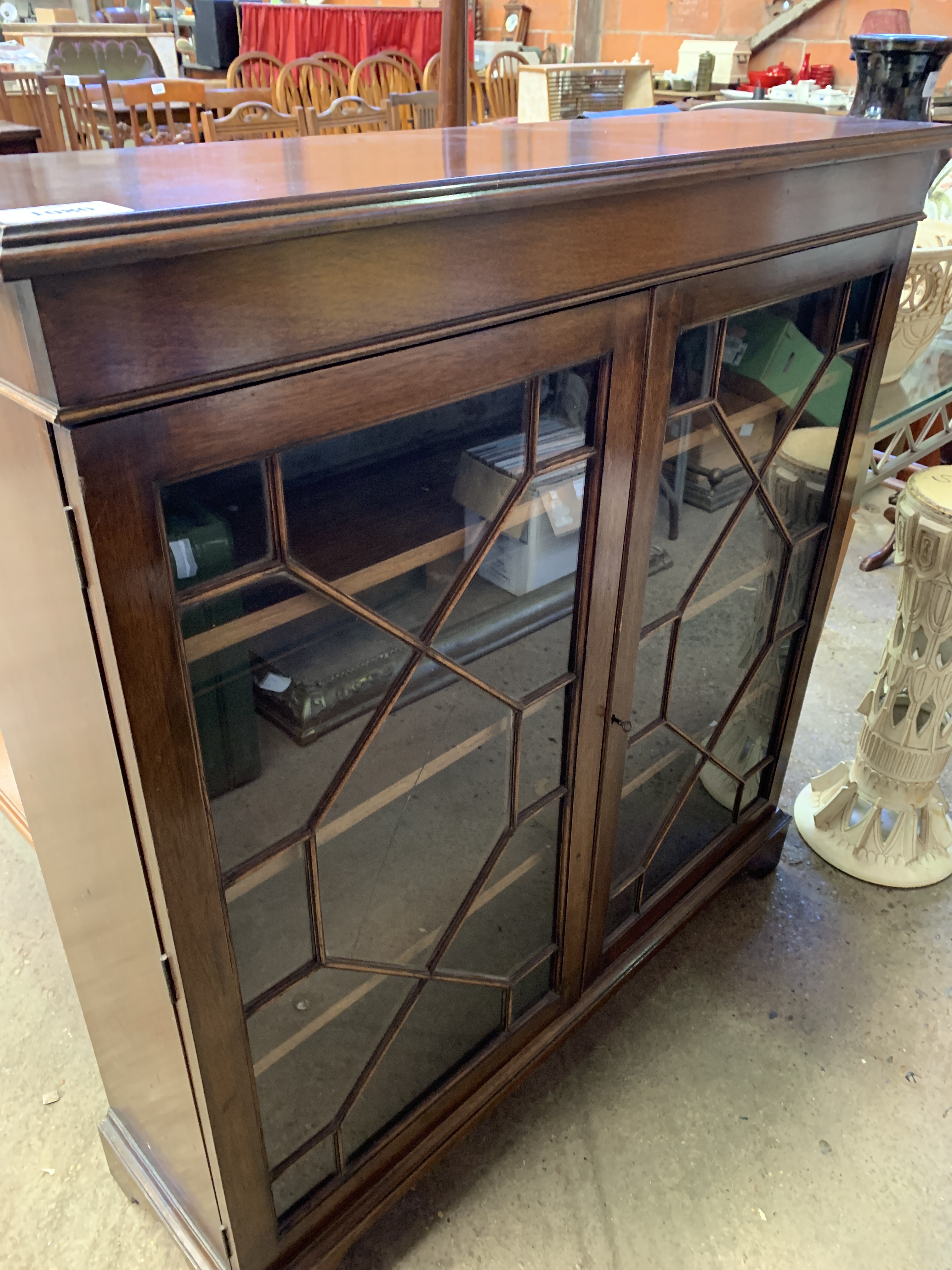A mahogany glass fronted bookcase