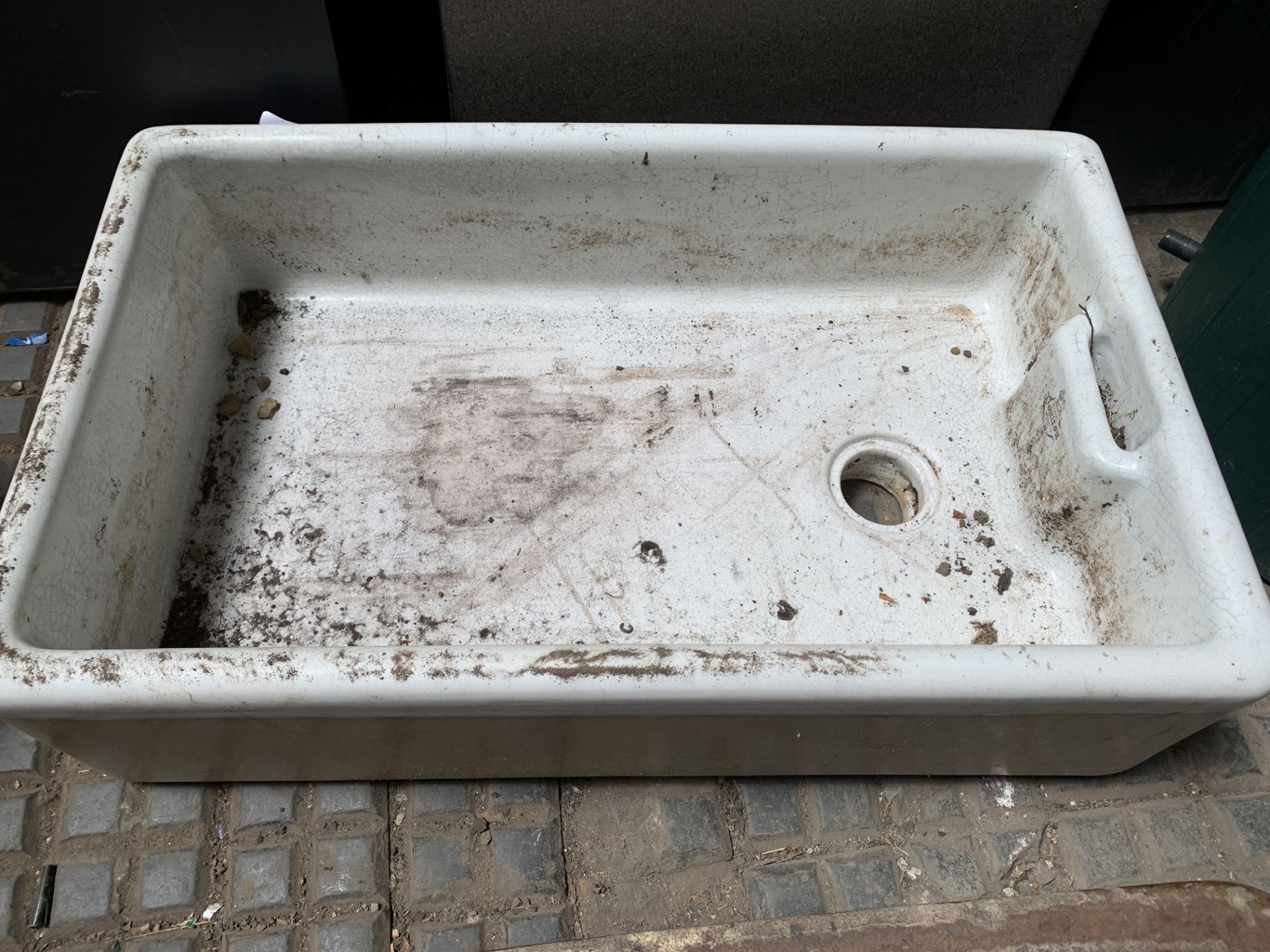 A white glazed stoneware Belfast sink