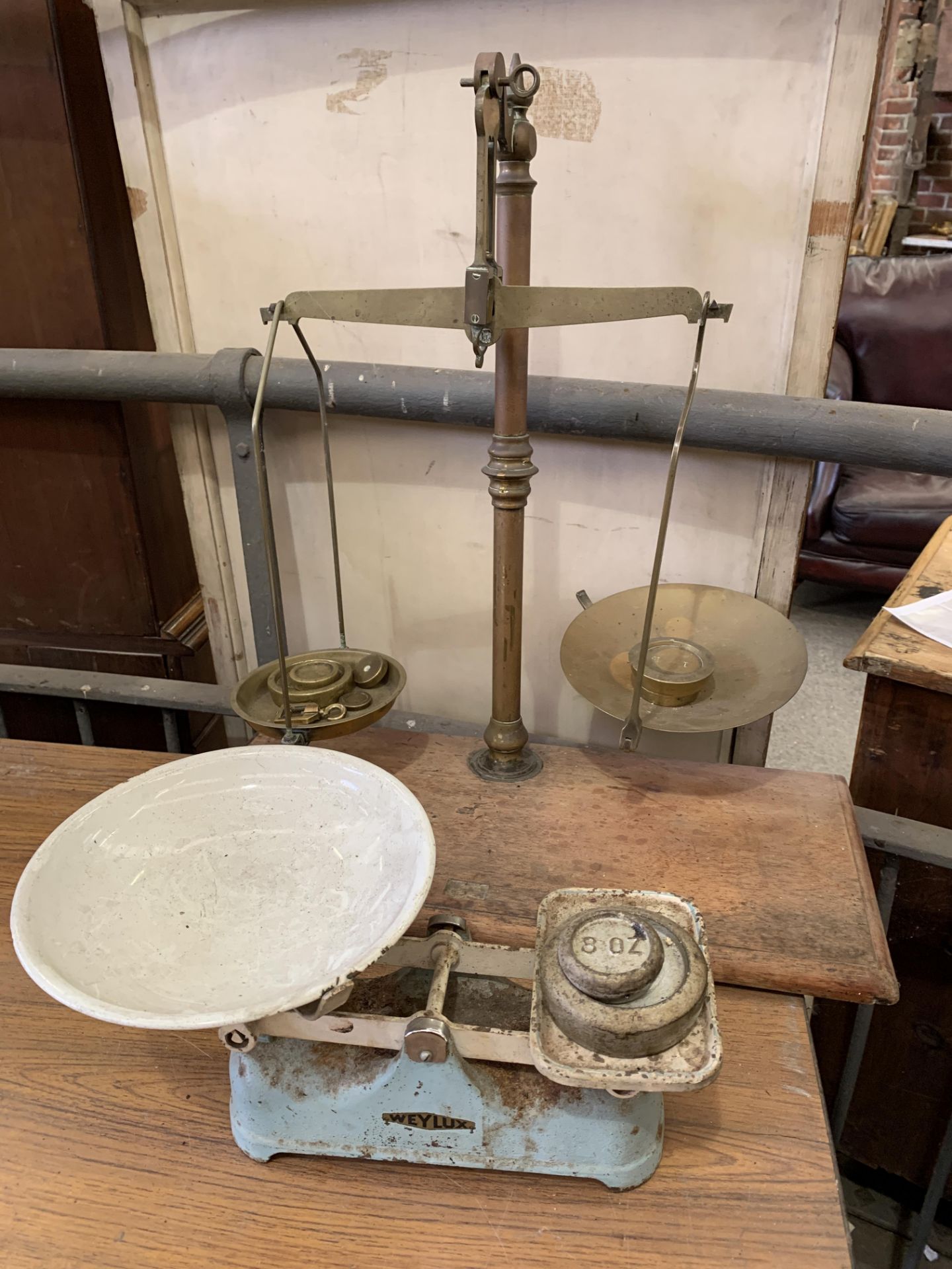 Set of brass balance scales on mahogany stand; together with a set of Weylux kitchen scales
