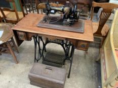 A Jones electric sewing machine on a cast iron Jones treadle base table.