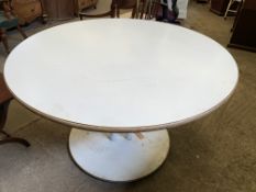 White circular table on pedestal of three tubes to circular base