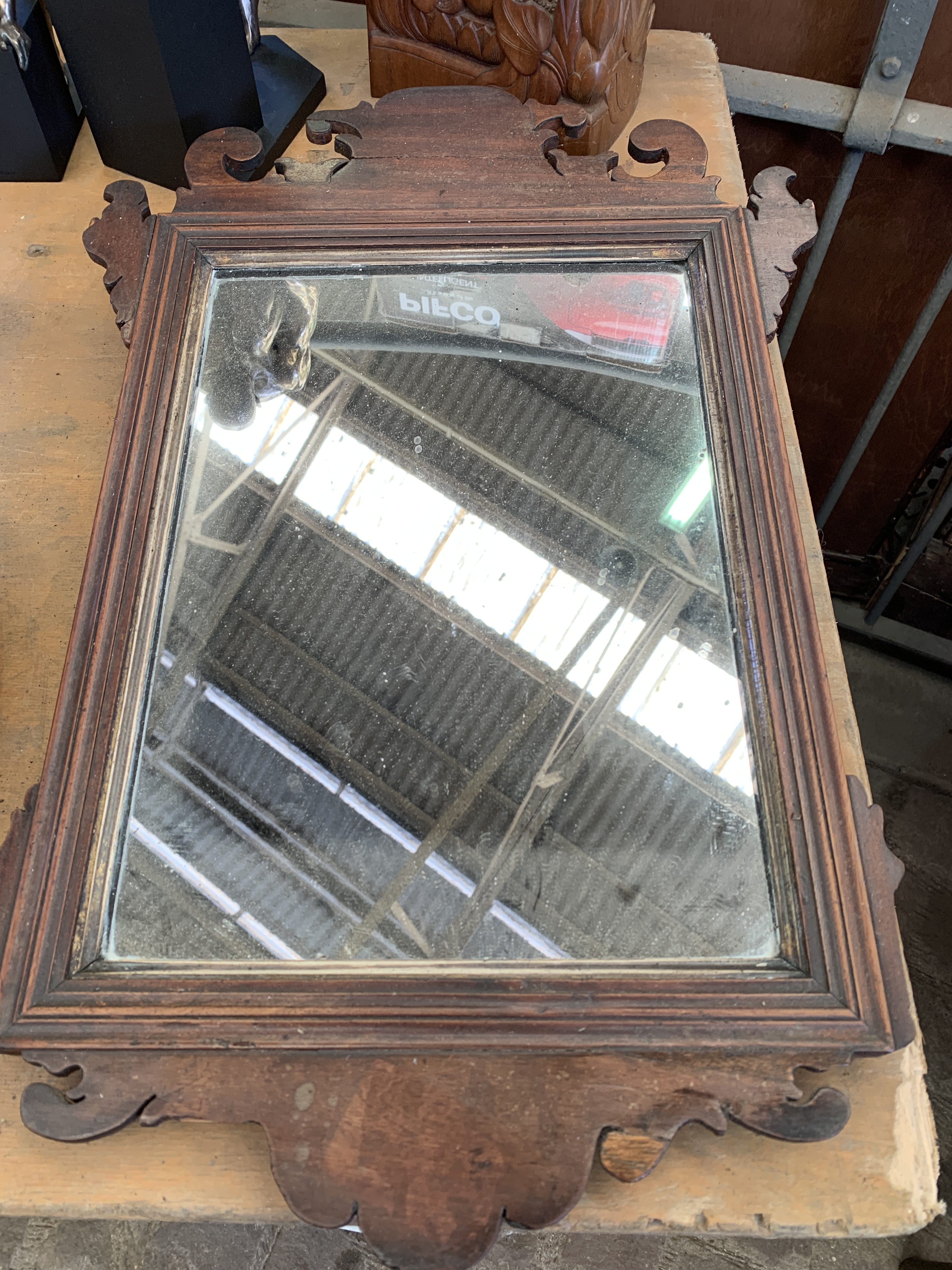 A pressed copper plaque together with a wood frame mirror