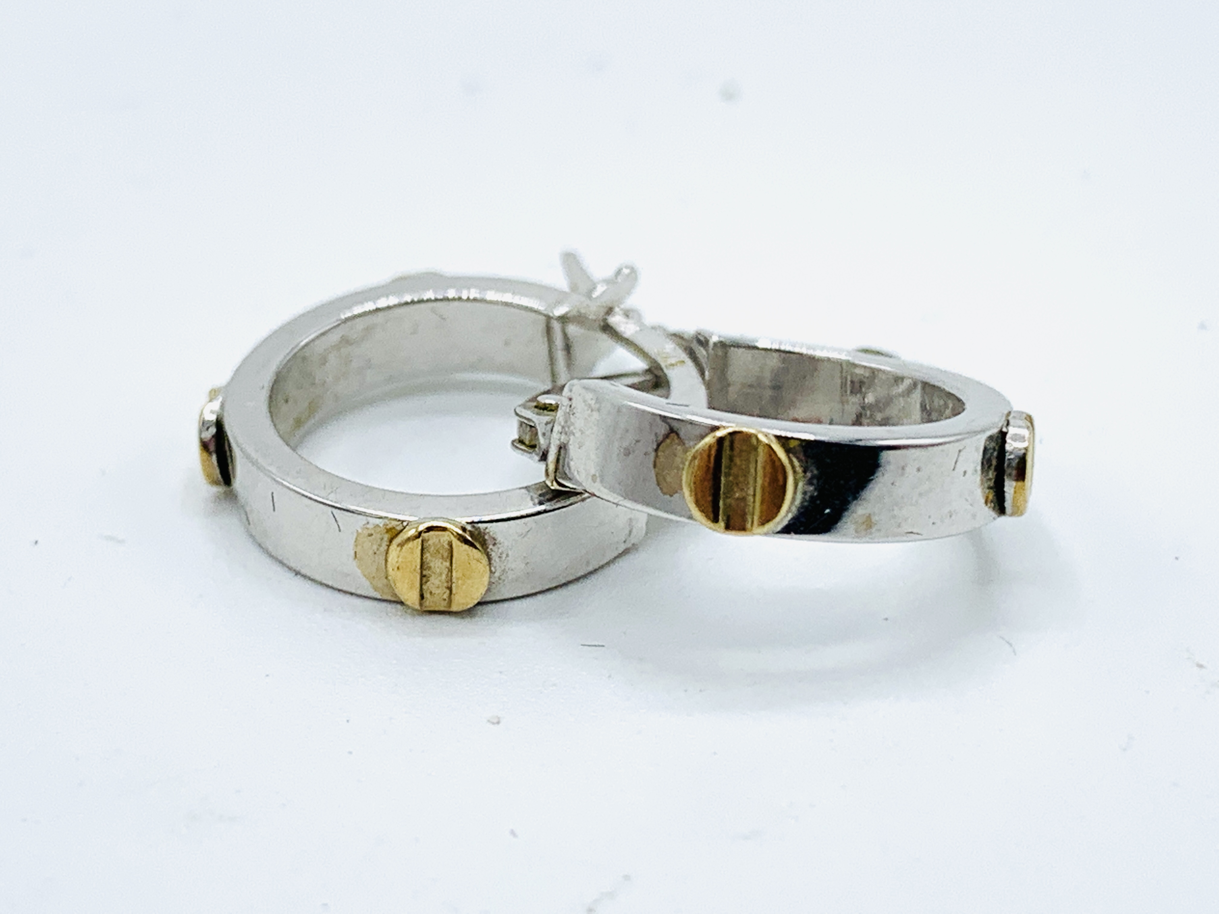 A pair of 9ct white and yellow gold small hoop earrings