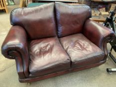 Dark red two seater leather sofa by Thomas Lloyd