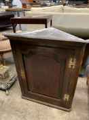 An early 19th century mahogany wall cupboard