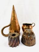 A Victorian copper ale warmer, two copper jelly moulds and a copper jug