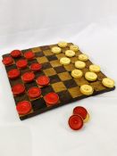 Inlaid chequerboard together with 14 red and 13 white draughts pieces