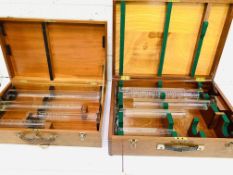 Two boxes containing standard glass measures