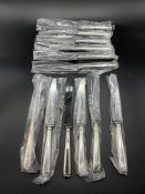 Twelve unused silver handled Hanoverian pattern knives hallmarked Sheffield 1992 by Terry Shaverin