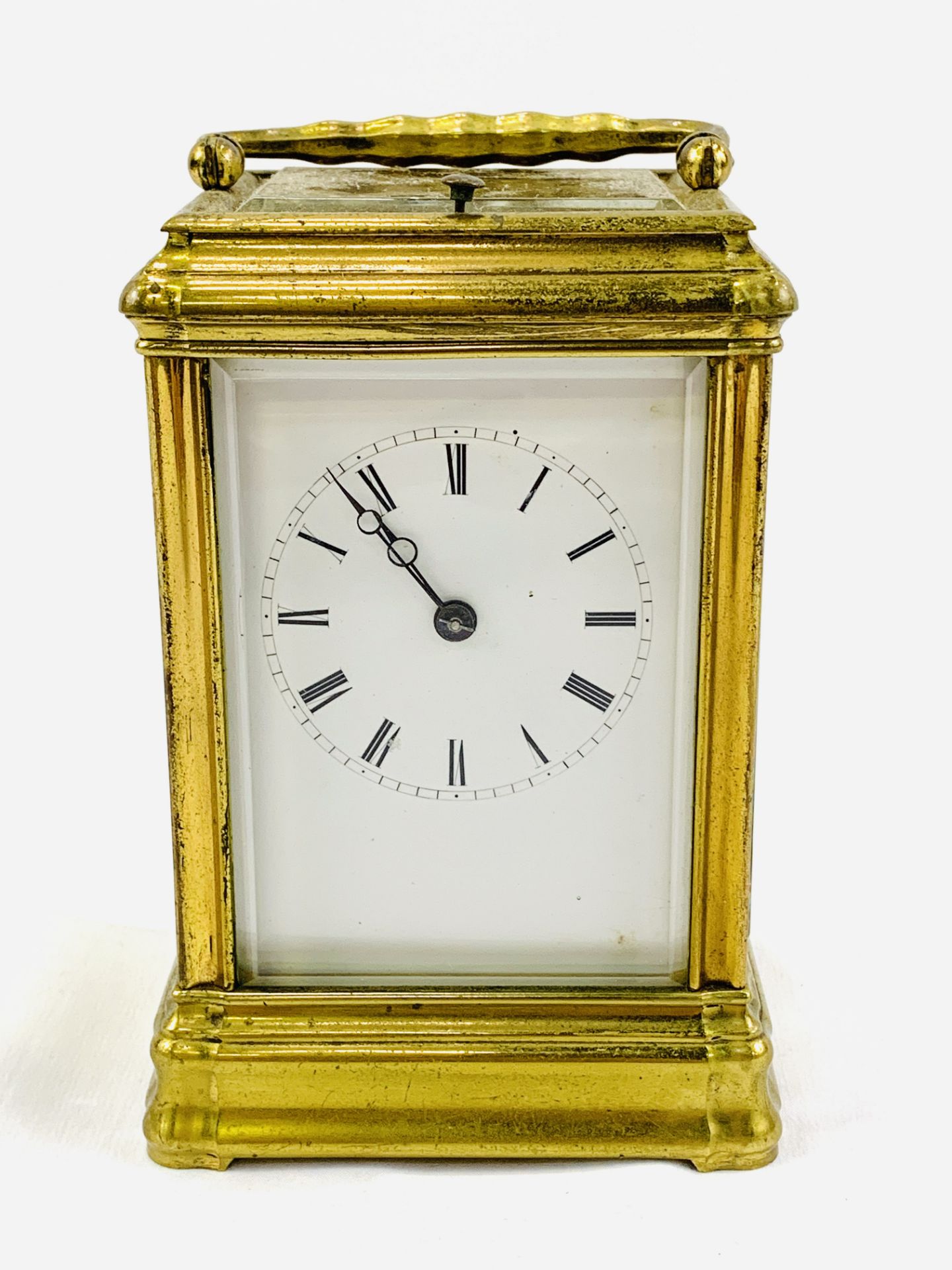 Brass case carriage clock with visible escapement, complete with key